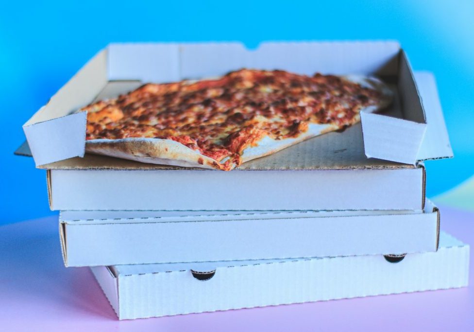 brown and white pizza on white box